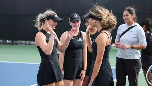 Women's Tennis shares a high five prior to a match