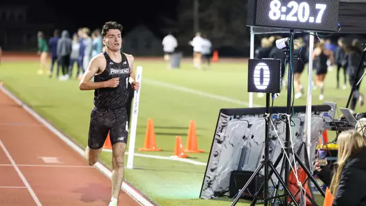 Men's track runner Cormac Dixon winning at the Friar Invitational