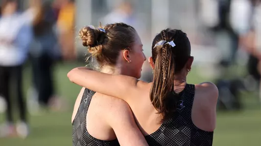 Grace Weston hugging teammate at Friar Invitational 