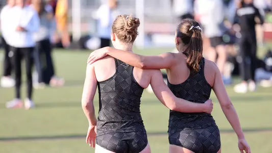 Grace Weston hugging teammate at Friar Invitational 