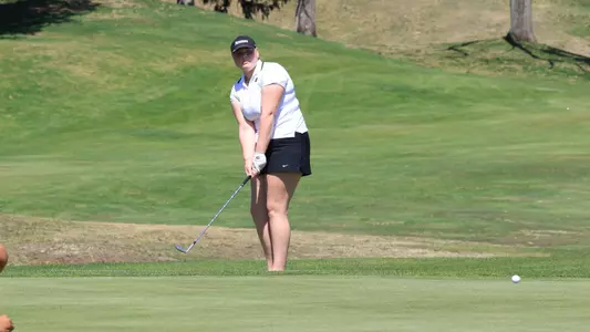 Women's golf player Myla Bisceglia hitting a chip at the Stonehill Senior Showdown