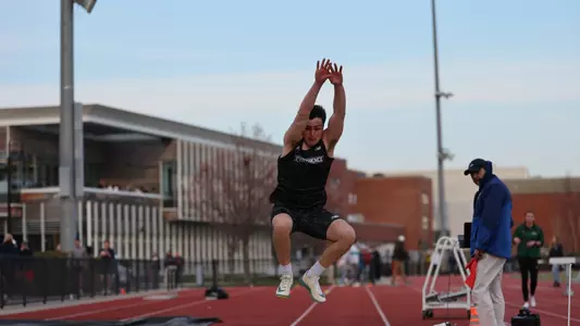 Nik Ventura competing in the long jump at Friar Invitational 