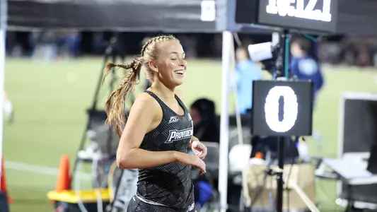 Kaleigh Higgins winning the open 3000 meter race at Friar Invitational 