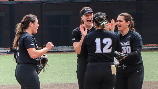 Softball teammates celebrate on the mound together in Providence, R.I.