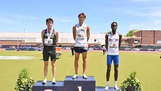 Eliott Pugh standing on podium with silver medal 
