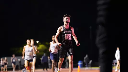Cormac Dixon winning the 5000 meter at the Big East Championship 