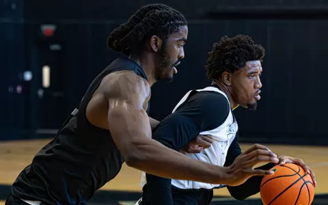 Samson Aletan plays defense on teammate during practice on June 16