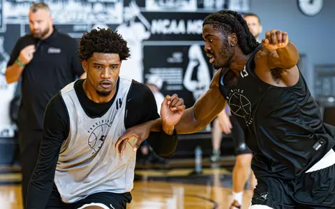 Samson Aletan plays defense on teammate during practice on June 16.