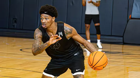 Dink Pate dribbles basketball during practice 