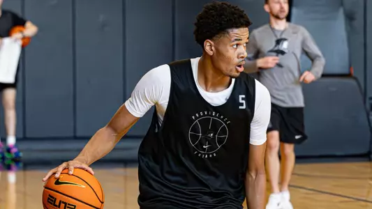 Clyde Walters dribbles basketball during practice