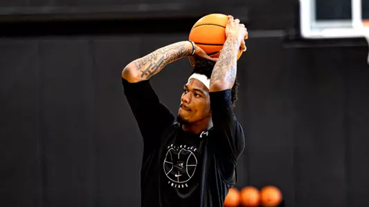 Men's basketball player Dink Pate shooting a shot during a practice