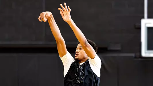 Men's basketball player Clyde Walters finishing a shot during a practice