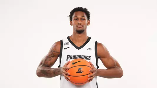 Men's basketball player Devin Vanterpool poses with a basketball in his hands during a photo shoot