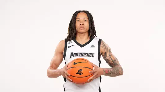 Men's basketball player Malik Mack poses with a basketball in his hands during a photo shoot 