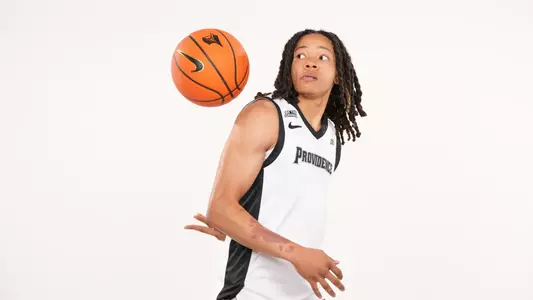 Men's basketball player Malik Mack poses throwing the ball behind his back during a photo shoot