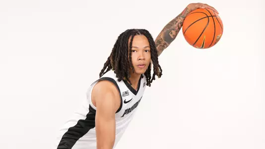 Men's basketball player Malik Mack poses dribbling a basketball during a photoshoot