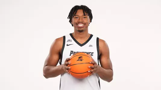 Men's basketball player Jacob Bannarbie posing for a picture