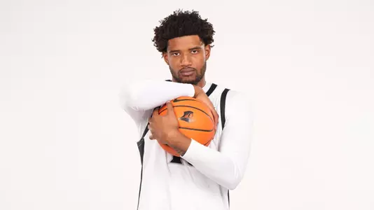 Men's basketball player Arrinten Page posing at a photoshoot