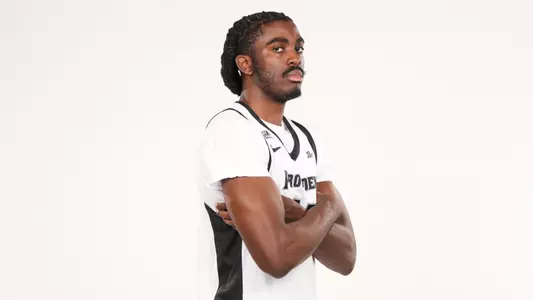 Men's basketball player Samson Aletan posing for a photo