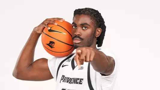 Men's basketball player Samson Aletan pointing towards the camera
