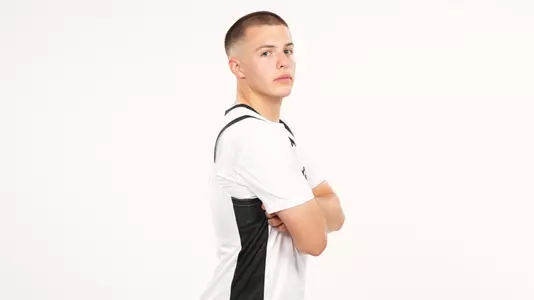 Men's basketball player John Jackson posing for a photo