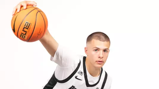 Men's basketball player John Jackson dribbling a basketball during a photoshoot