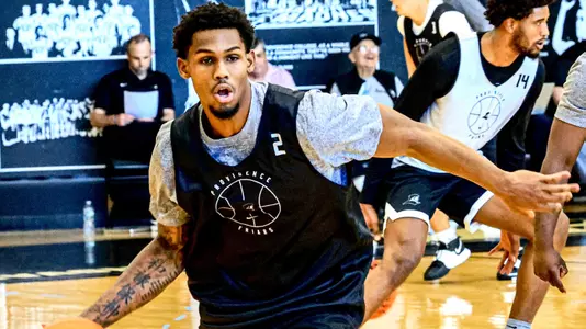 Men's Basketball player Devin Vanterpool protecting the ball from a defender during practice 