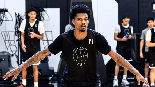 Mens Basketball Player Dink Pate playing defense in practice