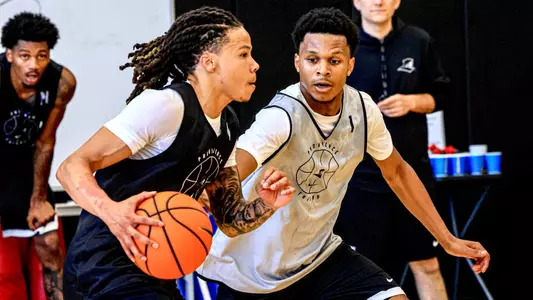 Men's basketball player Malik Mack driving with the basketball during a practice on June 8th 2026