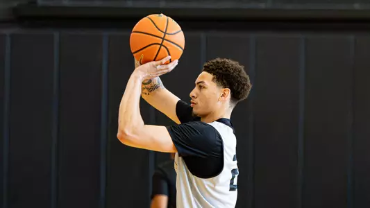 Men's Basketball player Miles Byrd taking a shot during practice 