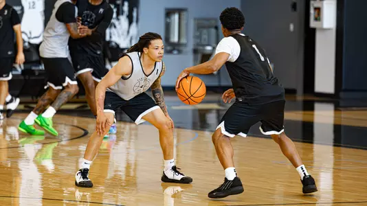 Men's Basketball player Malik Mack playing defense during a practice 
