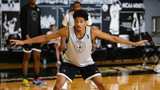 Men's basketball player Clyde Walters playing defense during a summer practice