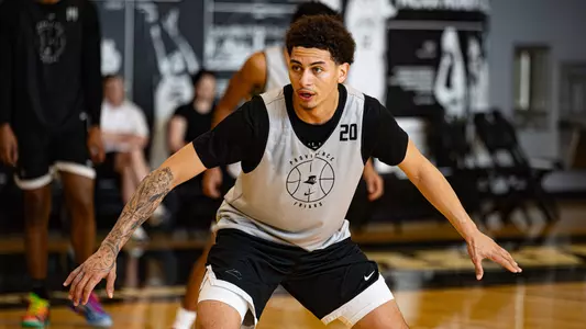 Men's basketball player Miles Byrd playing defense during a practice