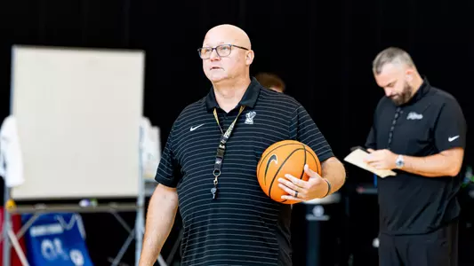 Men's basketball Director of Player Development Martin Stockwell holding a ball during a practice