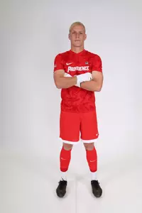 Tino Kneis crossing his arms and facing the camera 