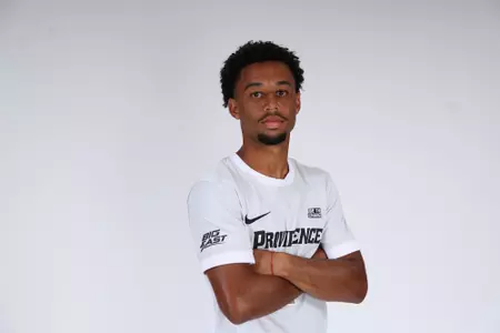 Caleb Williams arms crossed facing the side while posed 