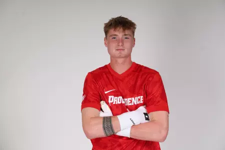 Ryan Carney arms crossed facing the camera 