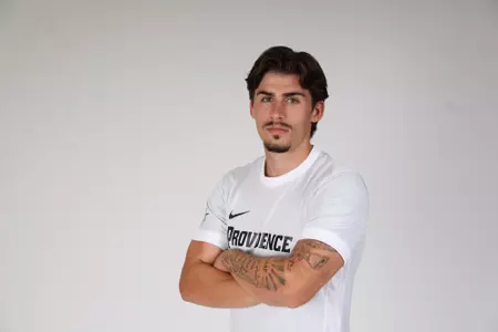 Alvaro Maneiro facing the side while crossing his arms 
