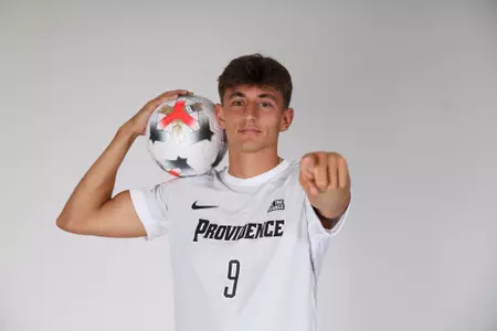 Sam Montalto holding ball on his shoulder and pointing at the camera 