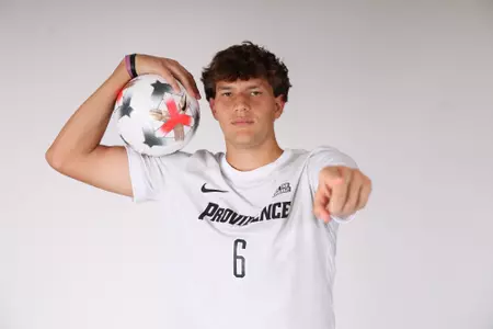 Jeremy Munoz holding the ball and pointing at the camera 