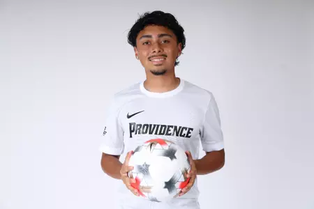Luis Gutierrez holding ball in front of him 