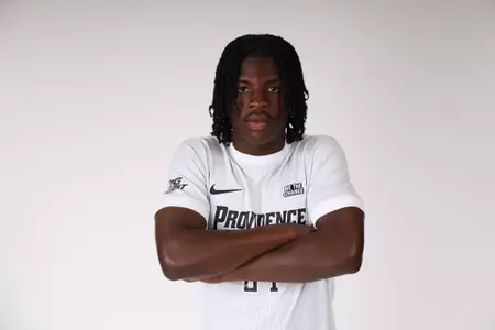 Mayowa Ajayi arms crossed facing the camera 