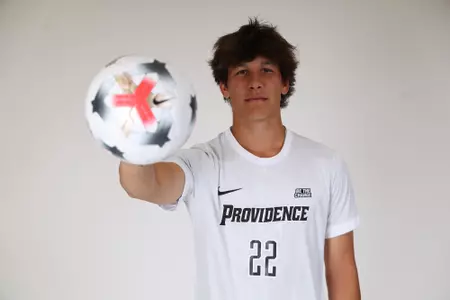 Jack Slade holding ball at the camera posed 