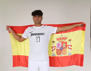 Adrian Garcia holding a flag in posed picture 