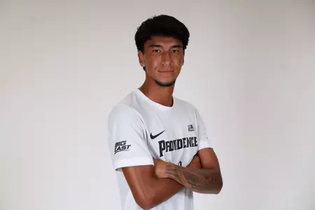 Steban Lopera arms crossed while facing sideways posed 