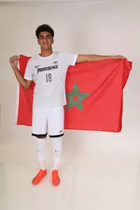 Karim Eljamal holding a flag behind his back 