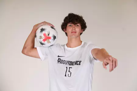 Tommy Tsouros ball on shoulder pointing at the camera  