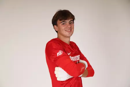 Aiden Tucker arms crossed turned towards the side 