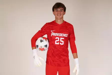 Aiden Tucker holding ball on hip posed