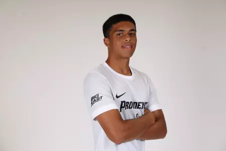 Ian Morel facing the side with arms crossed 